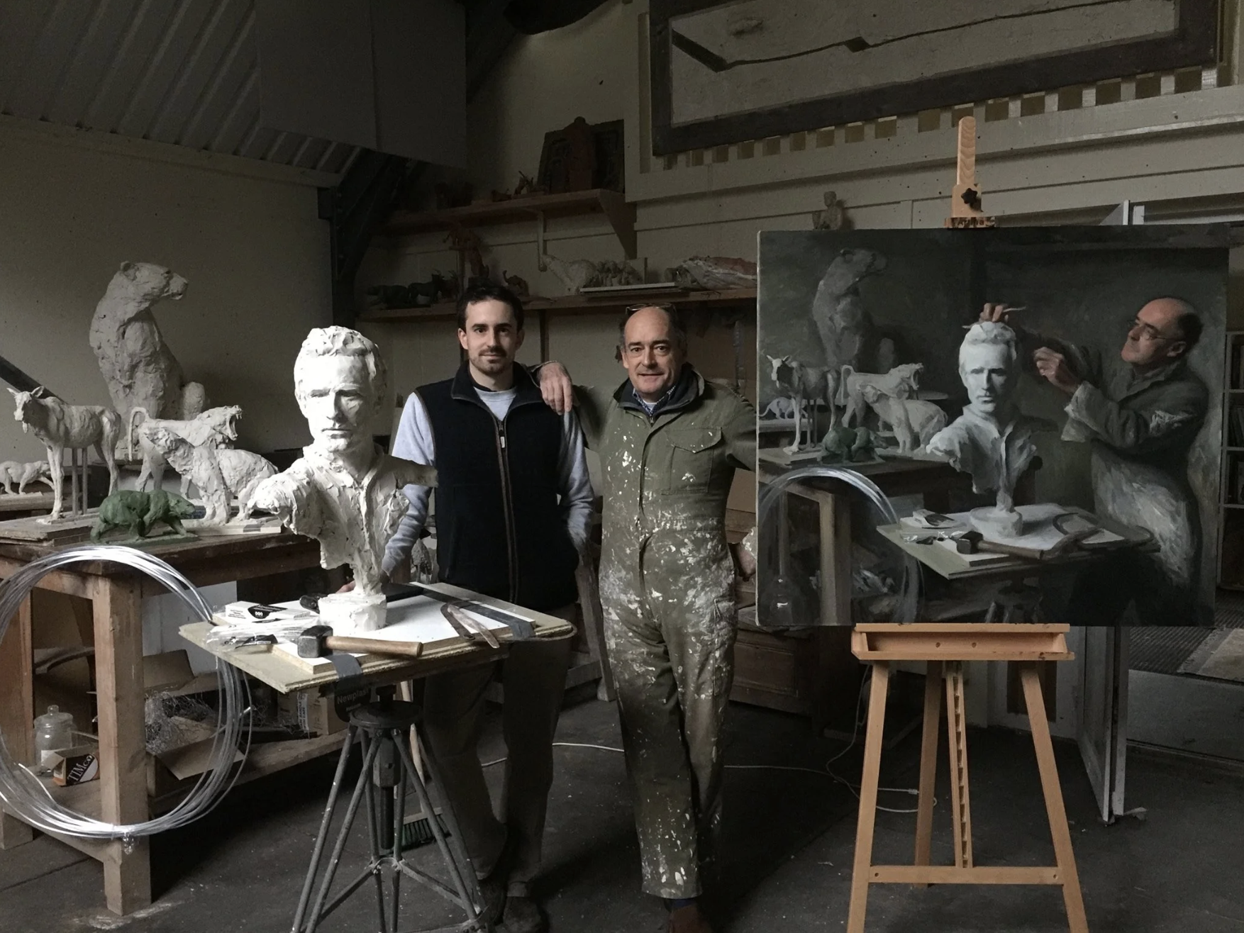 Painting of Jamie Coreth with is Dad, Mark COreth, in Mark Coreth's studio, next to a painting that Jamie Coreth did titled 'Dad Sculpting Me'. The painting also has the sculpture of Jamie present, there is a table with other smaller sculptures present